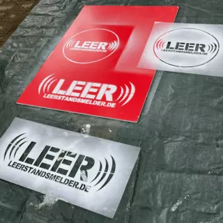 Signs to combat the housing crisis are being prepared with plastic stencils for demonstrations.