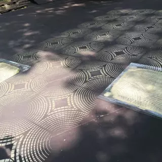 Two identical templates are used to work on a floor pattern