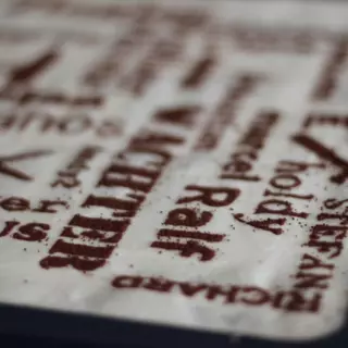 A tiramisu was sprinkled with a food stencil to create several words