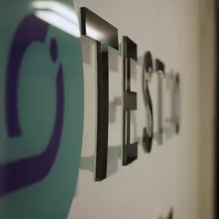 Acrylic glass logo in black with spacers as digital print