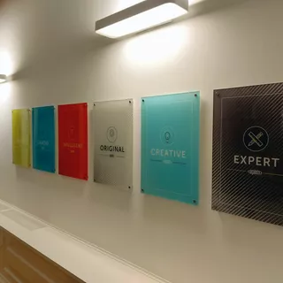 Several signs with motivational slogans made of digitally back-printed acrylic glass with spotlight
