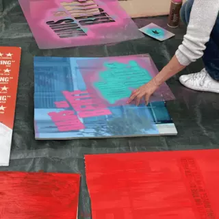 Various stencils are used to create pop art posters.