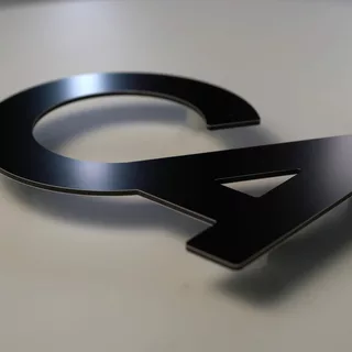 Schwarz glänzendes 3D Logo mit Abstandshaltern aus Aluminiumverbund.