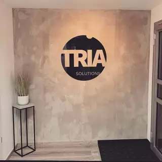 Acrylic glass logo on exposed concrete wall