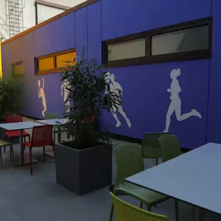 Silhouettes of people engaged in sports are painted on a wall